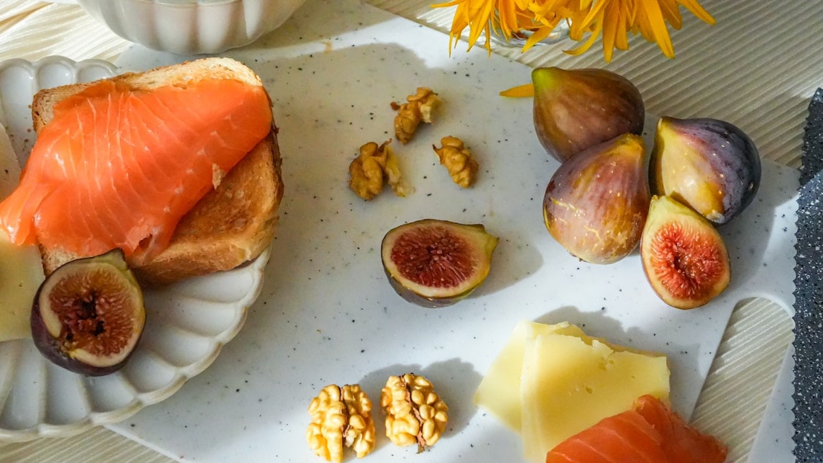 Cozy breakfast with tea, figs, cheese and salmon toasts